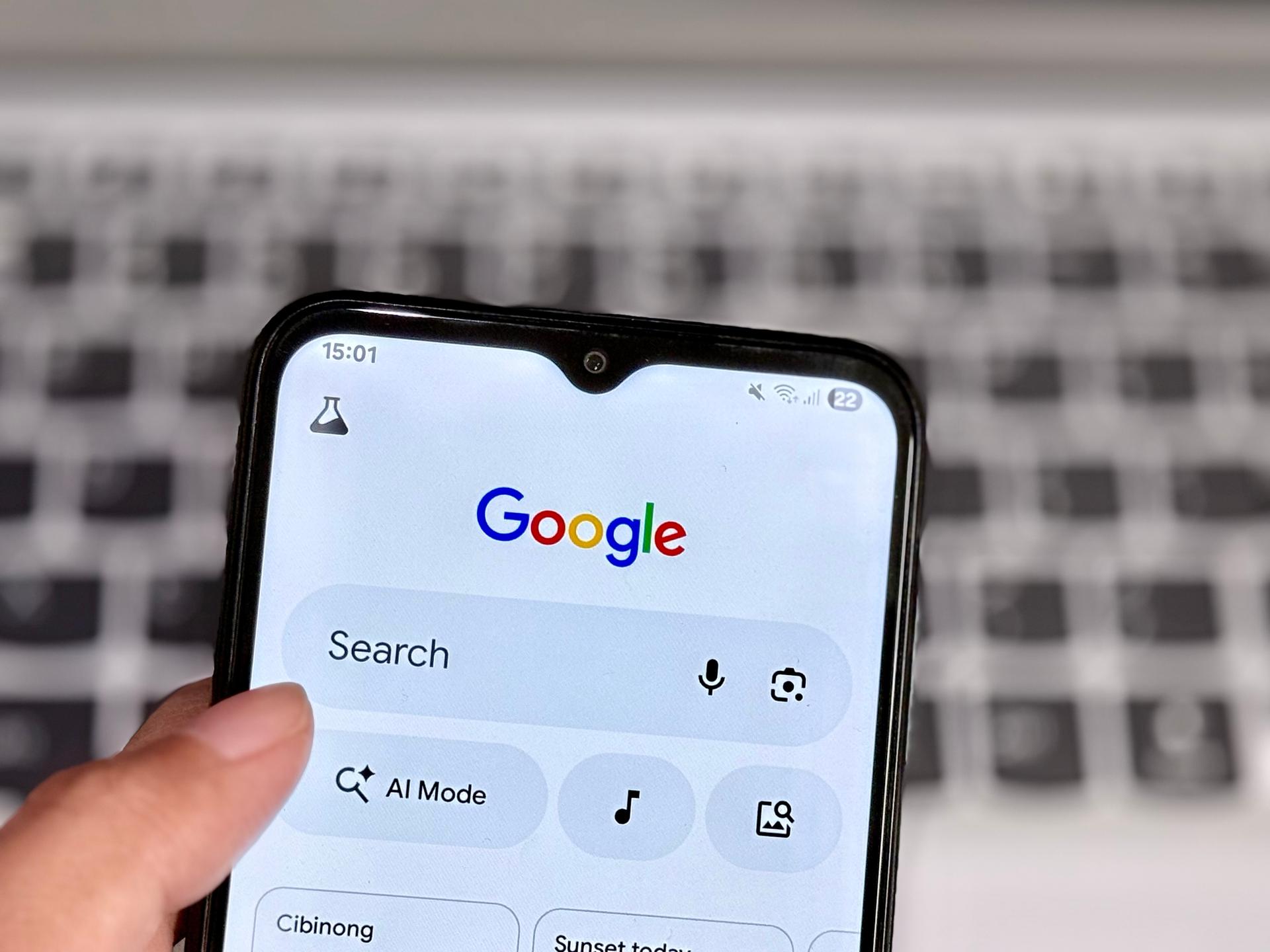 hand holding phone searching on google