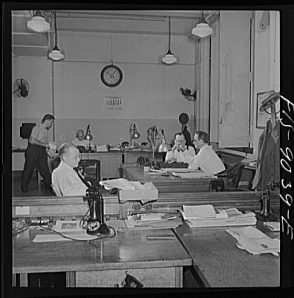 Editors working at desks in the New York Times newsroom in 1942.