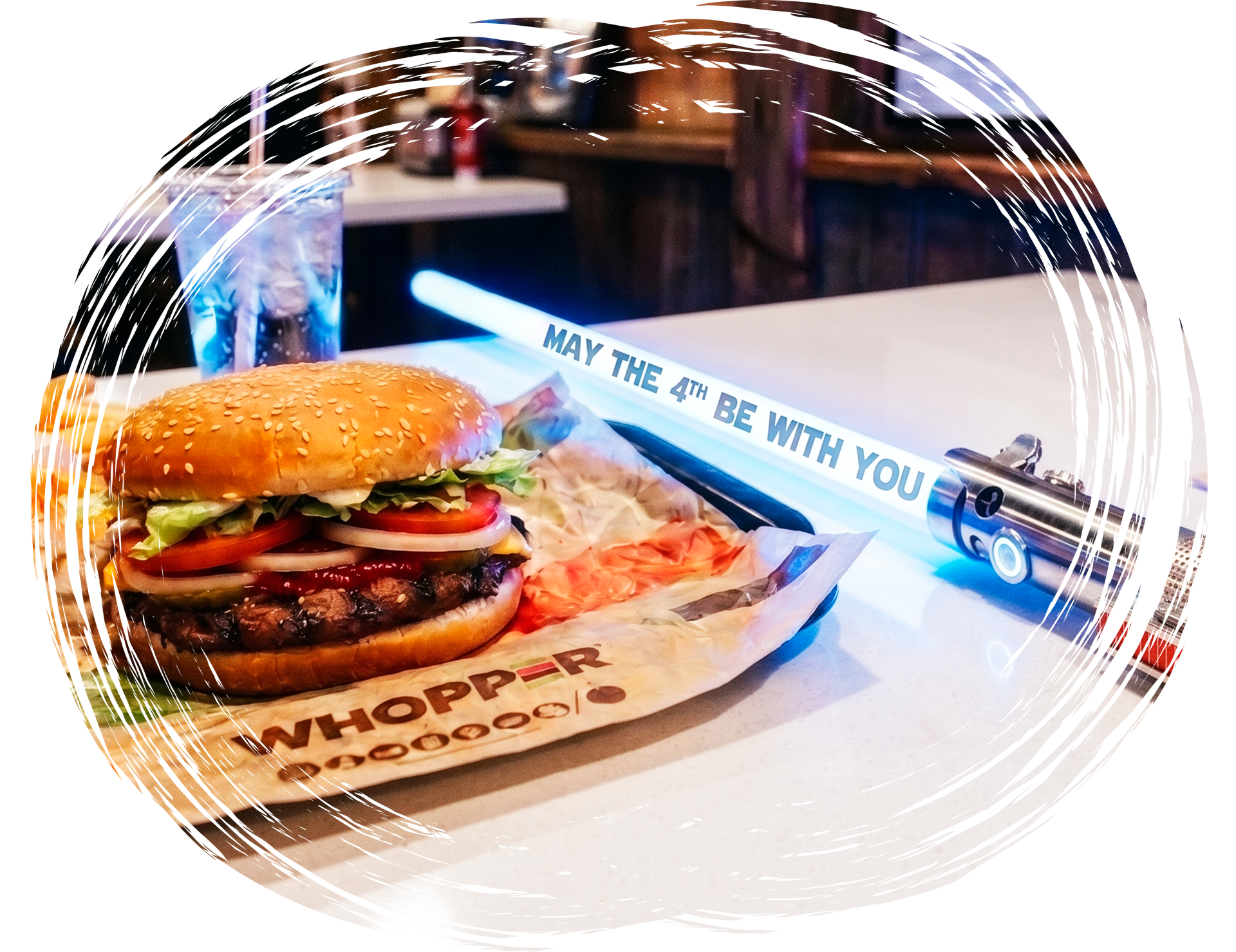 Burger meal with themed lightsaber prop displaying May the 4th message on table