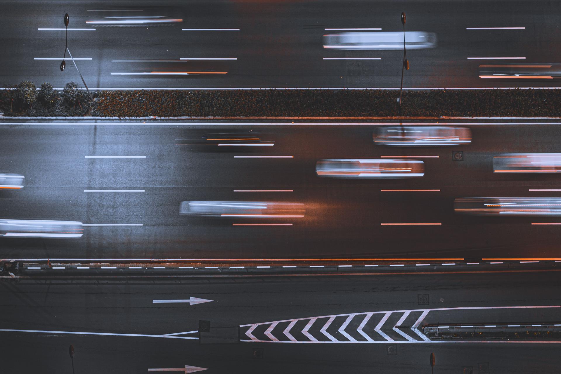 Nighttime highway traffic symbolizes the race to develop AGI as quickly as possible