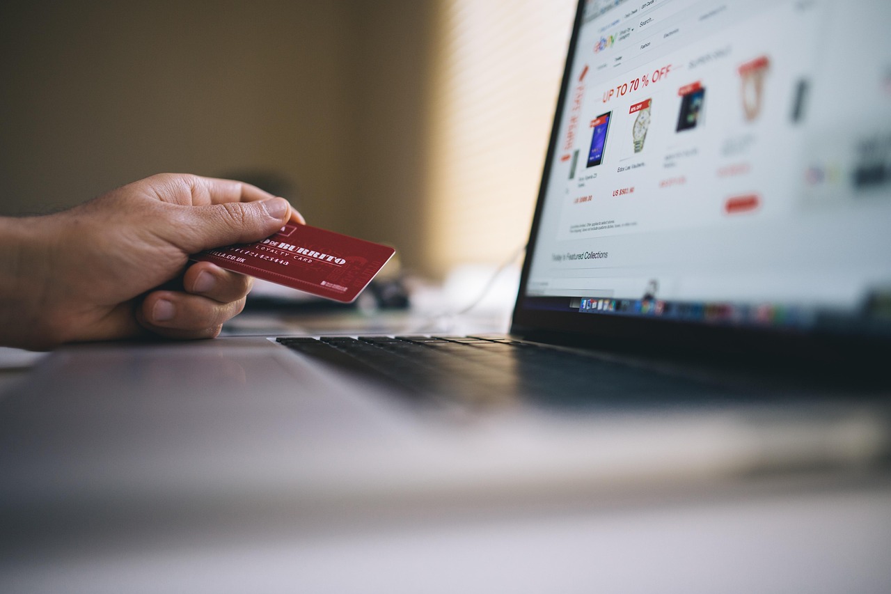 Shopper using a credit card to buy online after viewing an AI-generated ad