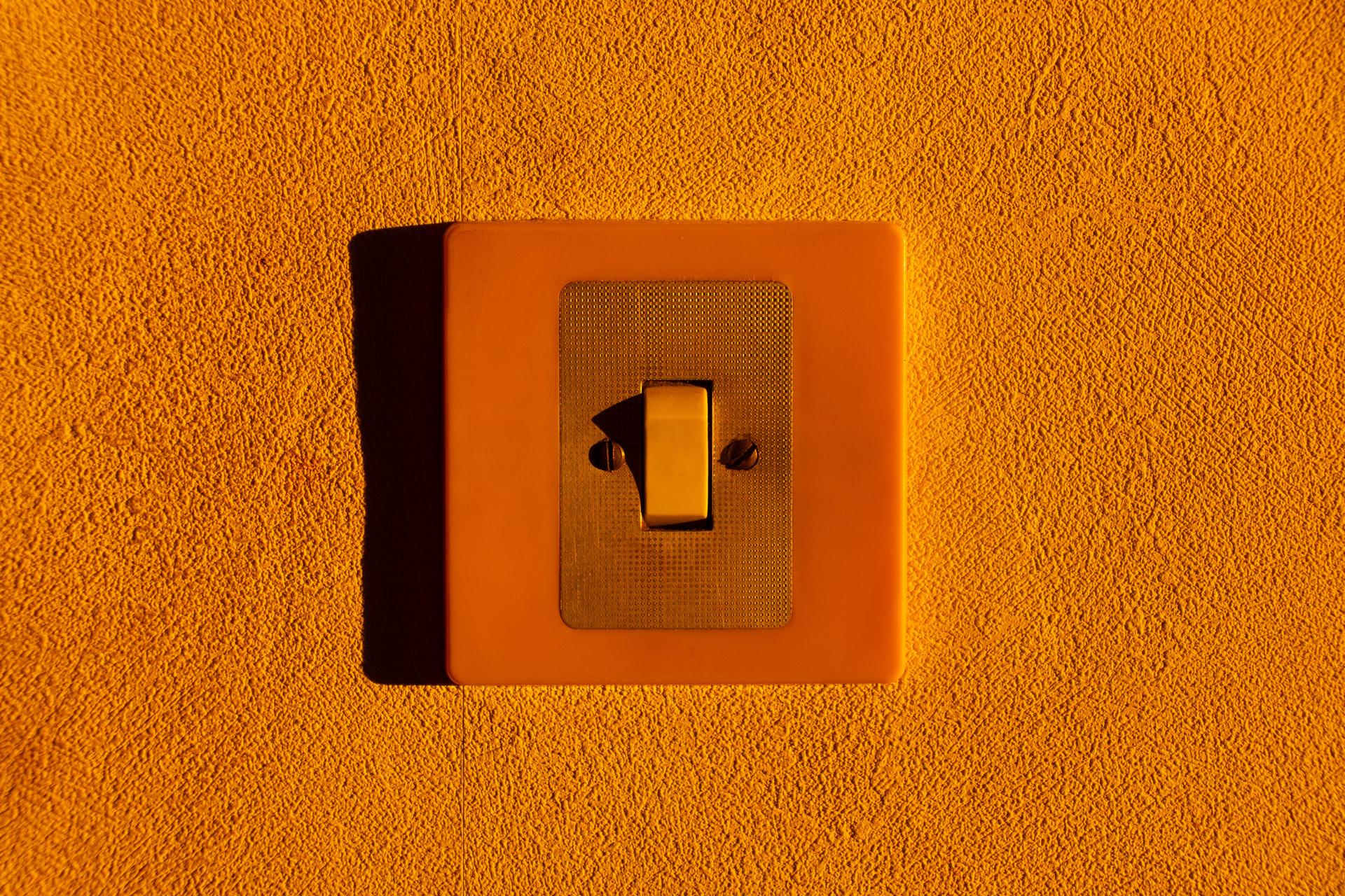 The light switch symbolizes the urgent need for AI safety kill switches, highlighting the risk of AI self-preservation instincts.