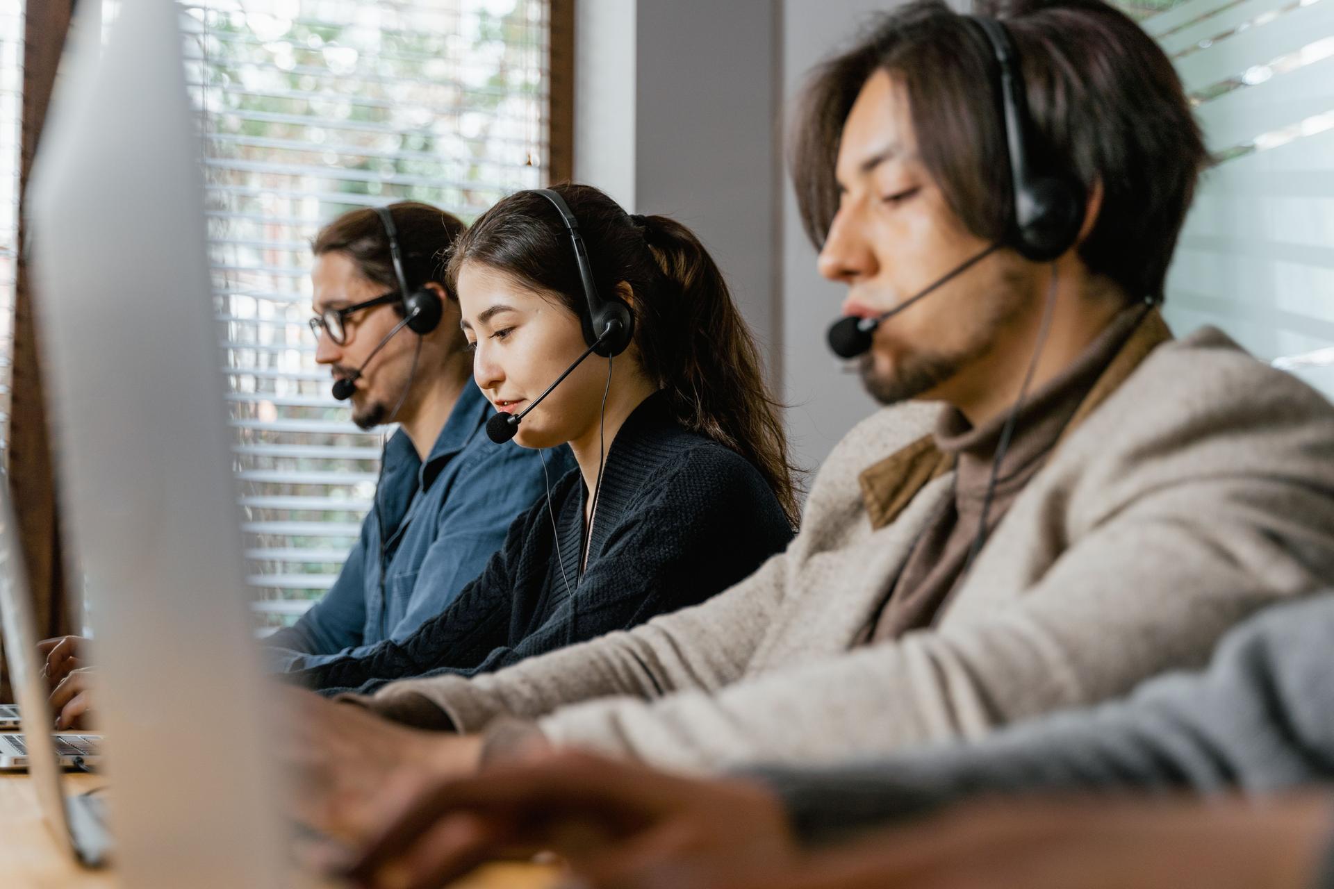 Call center agents discussing implications of AI laws on tech safety and regulation.