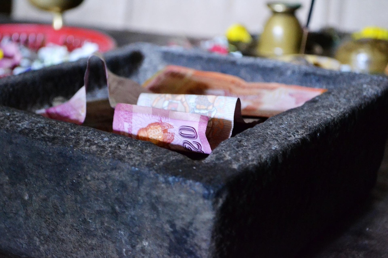 A stone container filled with banknotes symbolizing charitable donations for ai charity initiatives