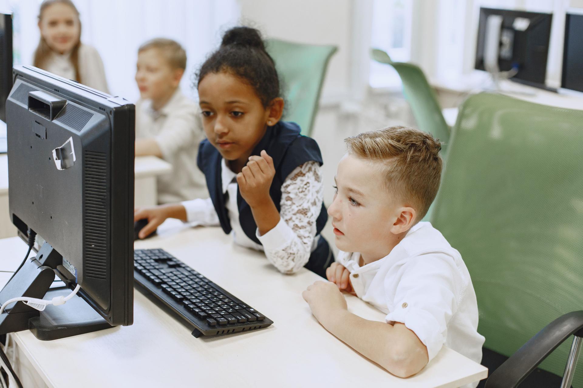 Safe AI Chatbot Rules for Children Children studying at a computer, where clear AI safety rules support learning