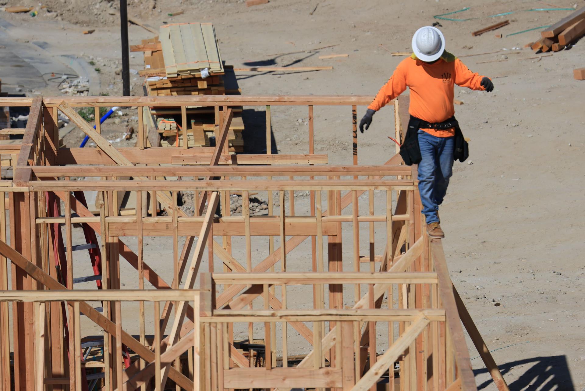 Construction Worker Focused on Safety in AI Development Construction worker ensuring safety while building, highlighting the need for AI safety measures in tech innovation