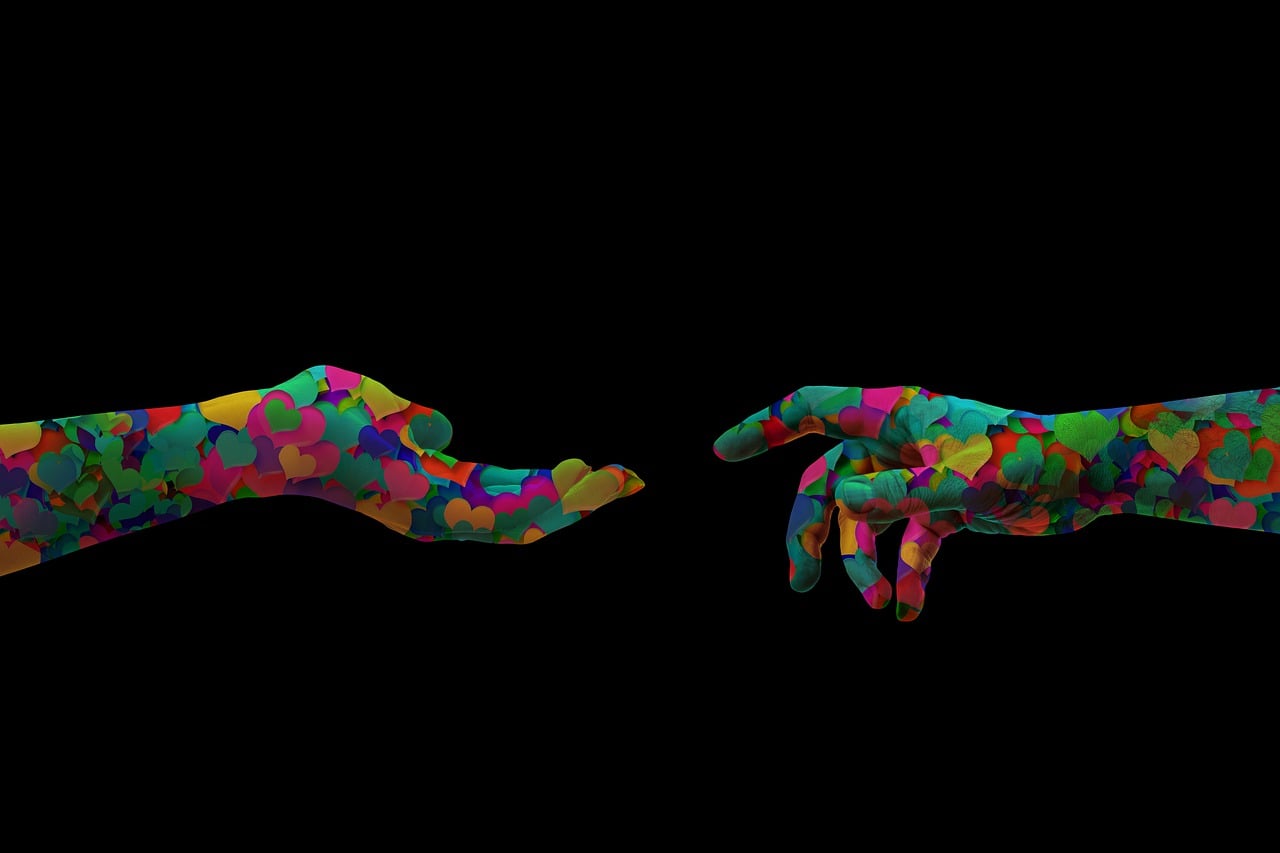 Colorful hands with heart patterns symbolize consumer trust in AI advertising.