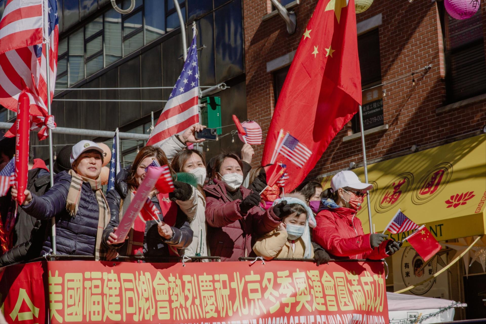 Group of US and China representatives celebrating AI safety talks amid accountability concerns.