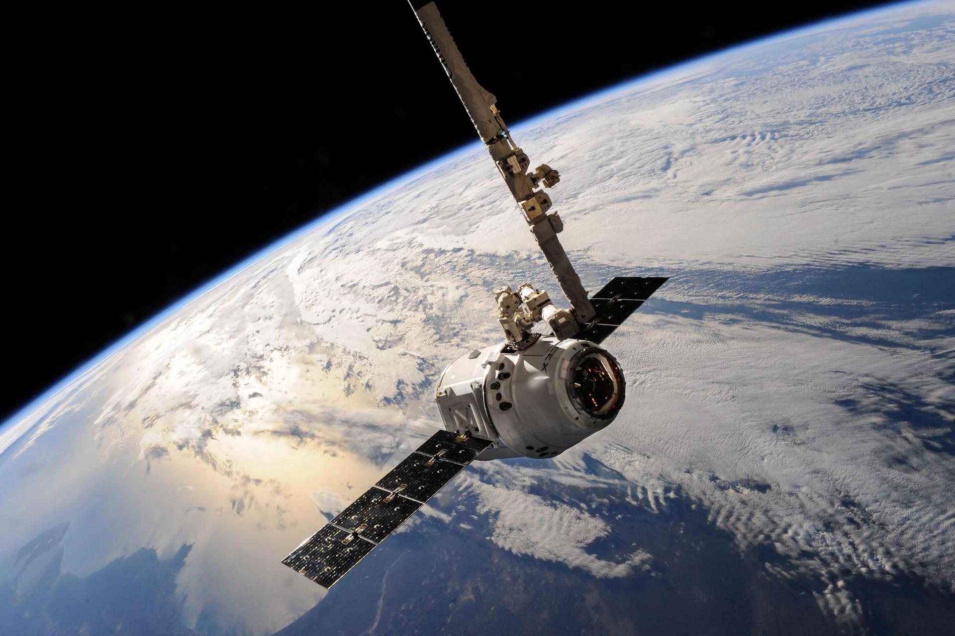 Google's satellite in orbit features solar panels for AI data processing.