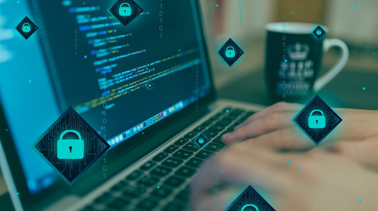 Nvidia AI Safety Platform Code and Cybersecurity Hands typing on a laptop with code and cybersecurity icons representing Nvidia's safety platform