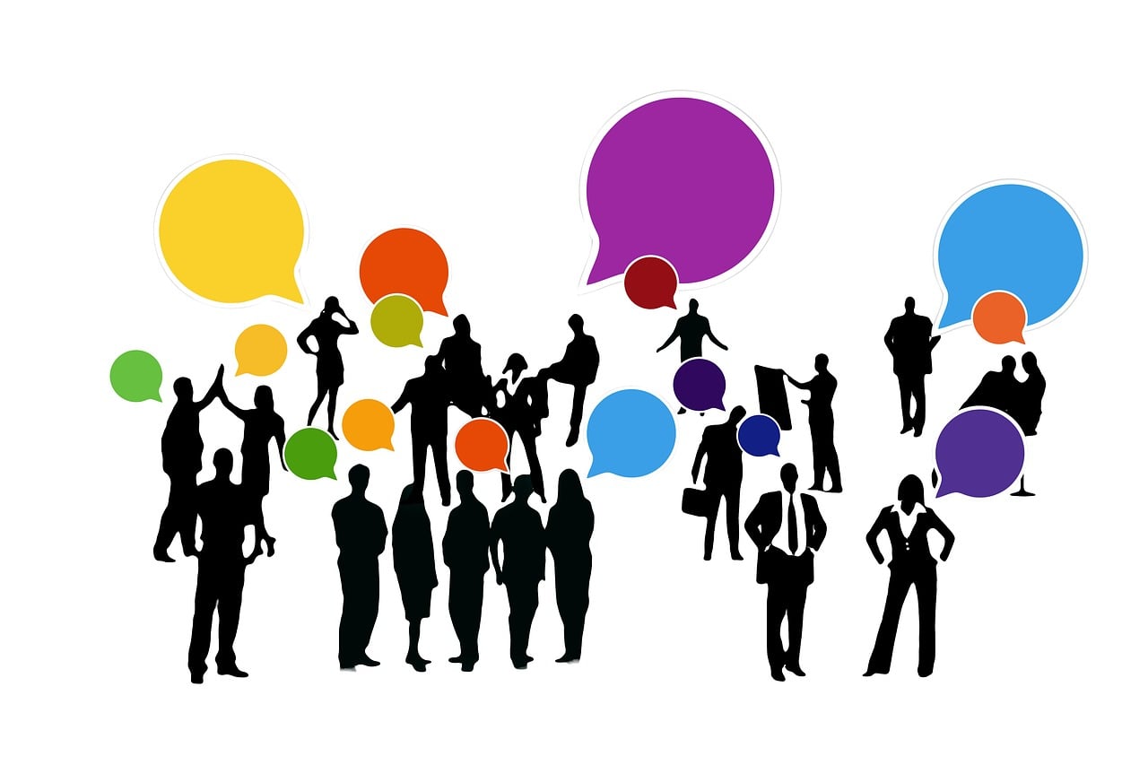 Silhouetted people exchange colorful speech bubbles, illustrating more useful conversations with adaptive AI interfaces.