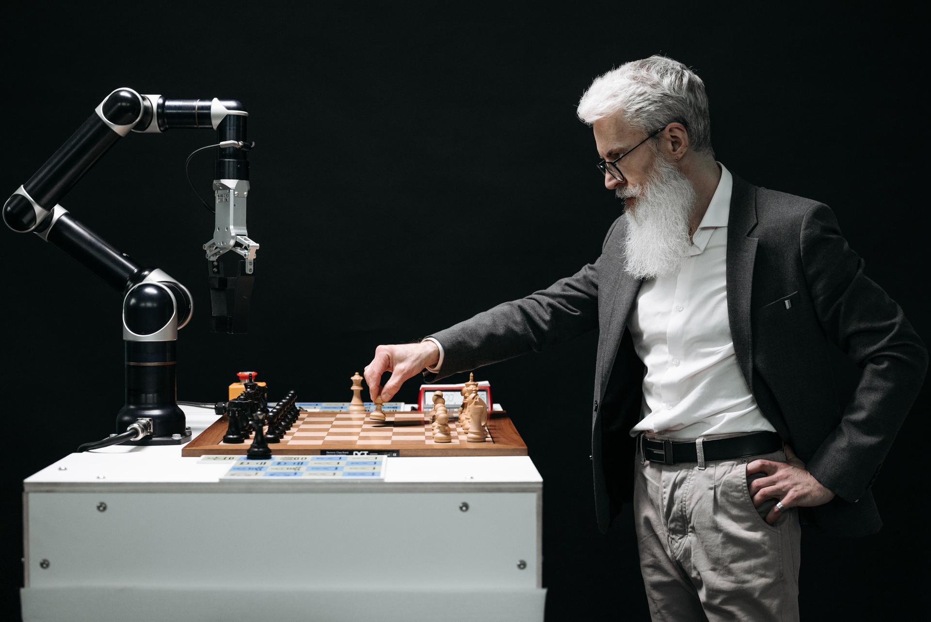 Man strategizing chess moves with a robotic arm, reflecting the interplay between human and ai agents in tech oversight discussions.