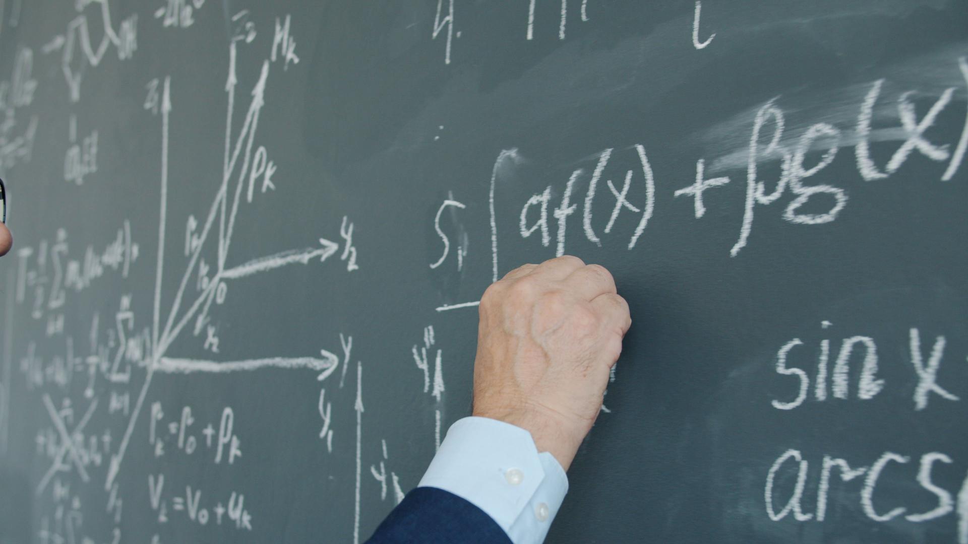 Mathematician writing equations related to AI-generated proofs from OpenAI's research release.