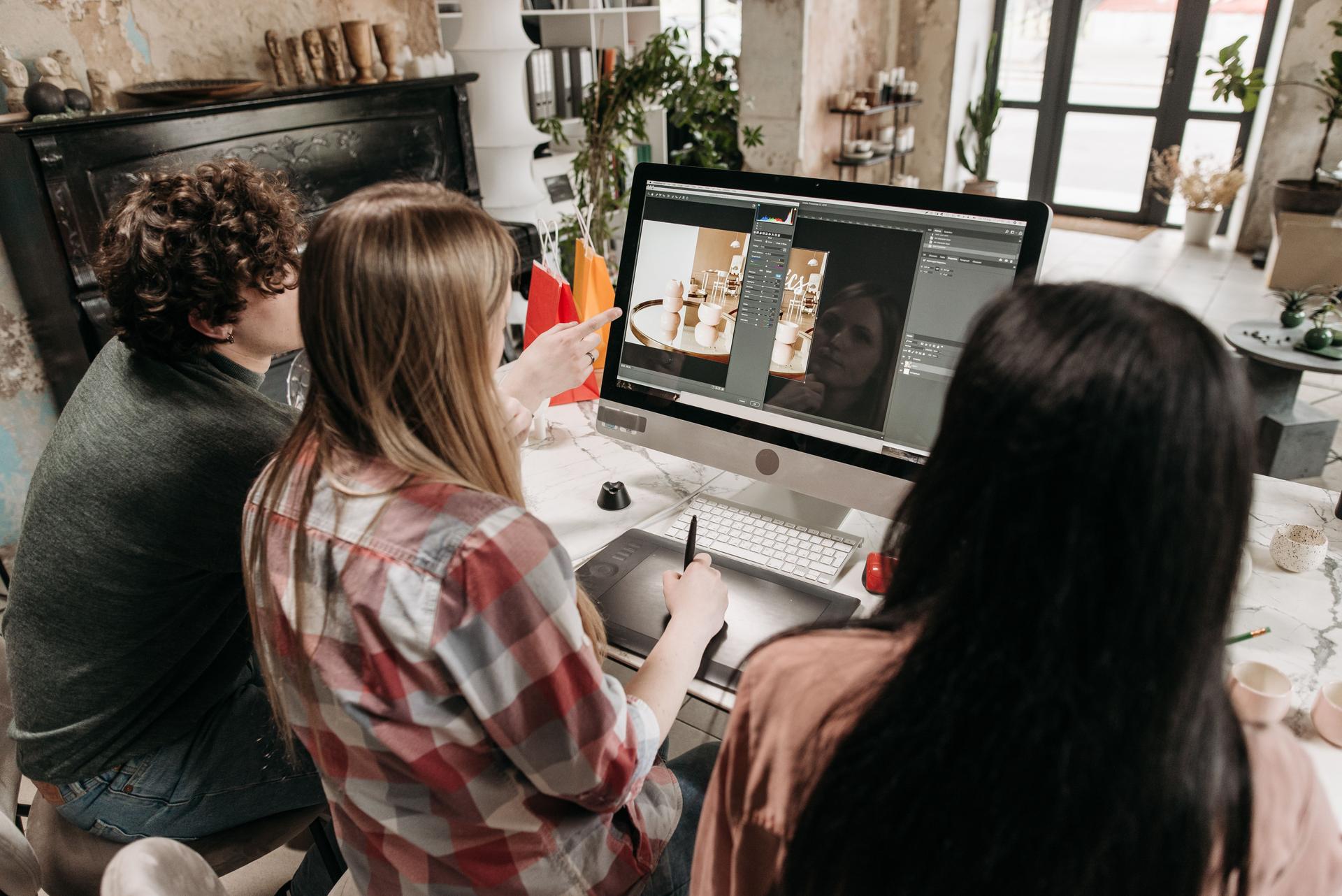 Creatives collaborating on digital design, highlighting issues in ai laws and copyright protection.