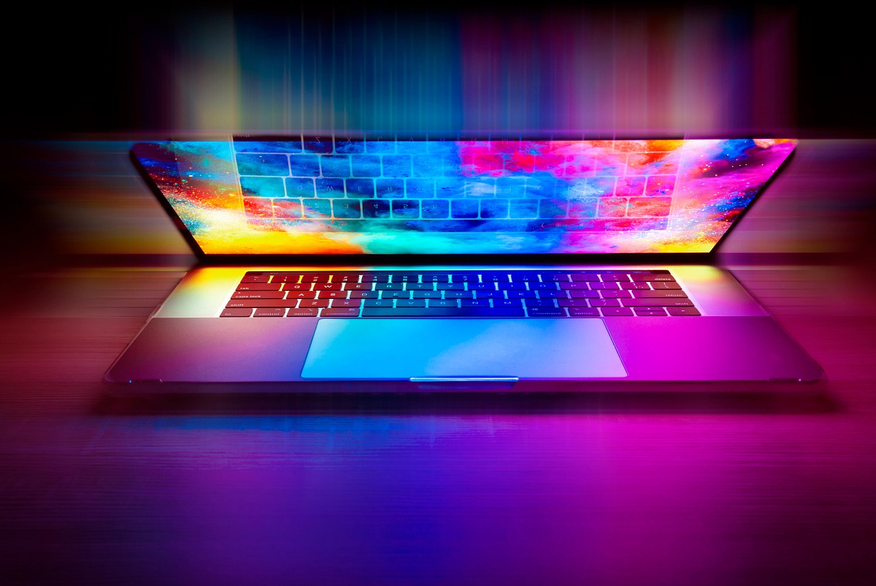 Laptop displaying colorful digital graphics for an article about public priorities for safe, controllable AGI development