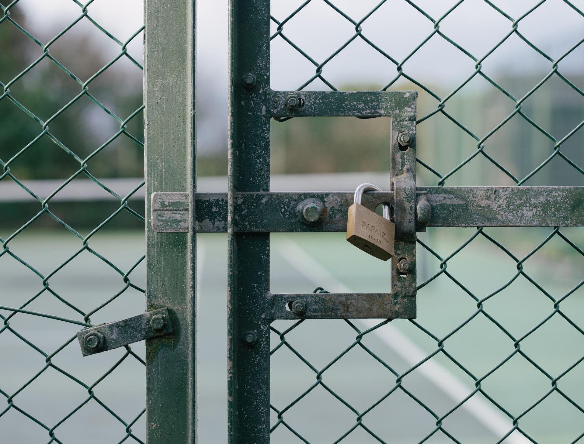 Secured Metal Gate Reflects AI Privacy Issues A secured metal gate symbolizes the privacy concerns raised by Meta's AI revealing user details unexpectedly.