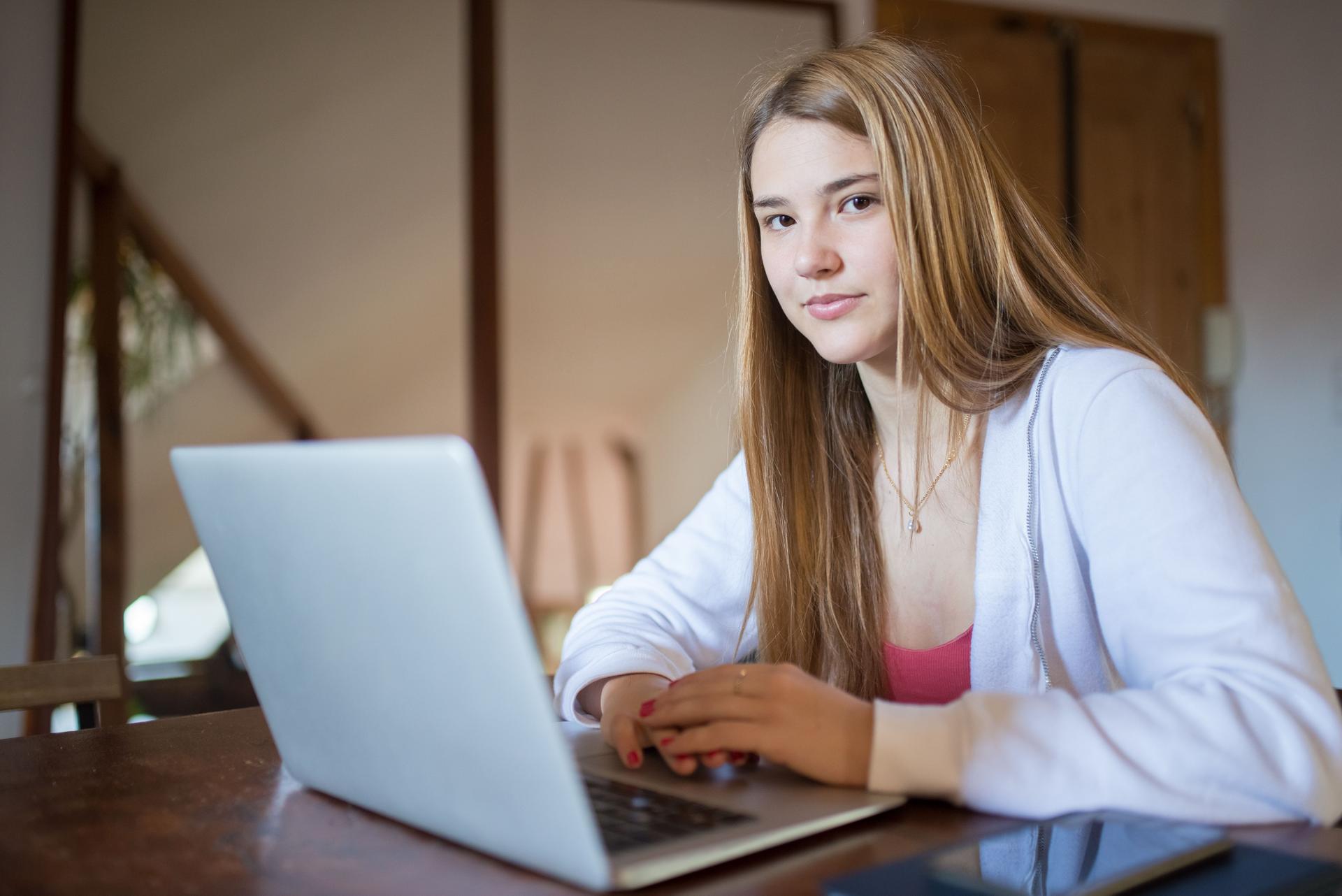 Teen using ChatGPT on a laptop in a cozy setting, reflecting safety concerns raised by Common Sense Media.