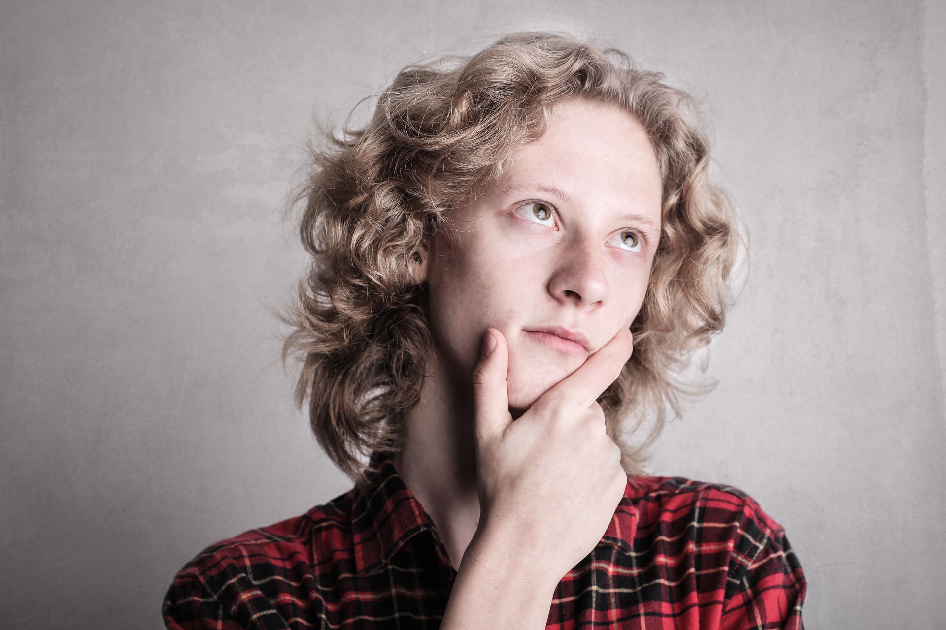 Contemplative Young Person on AI Judgment in Contracts Young person reflecting on the importance of human judgment in AI-driven contract awards.