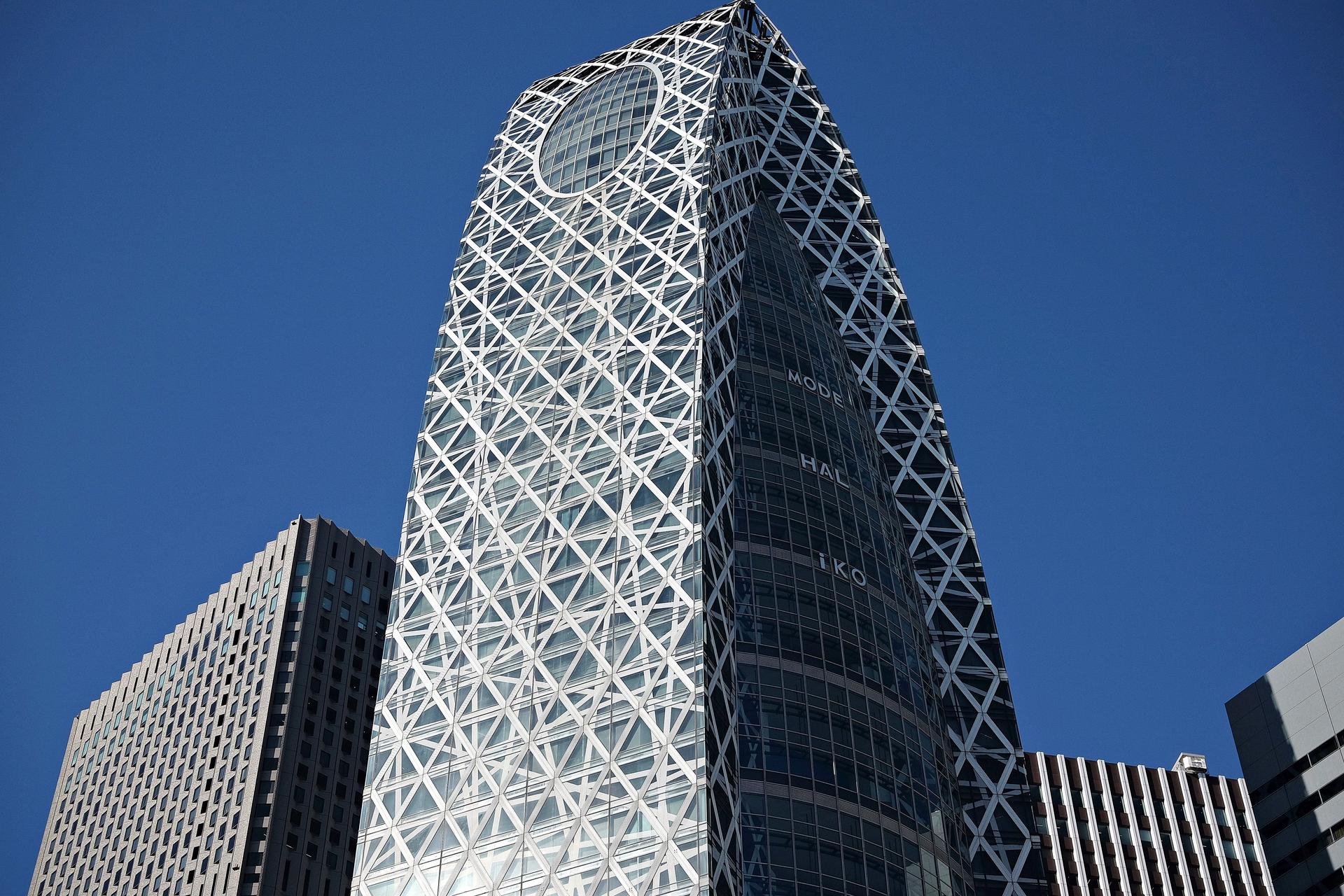 Modern skyscraper in Tokyo representing SoftBank's bold investment in OpenAI contributing to ai news