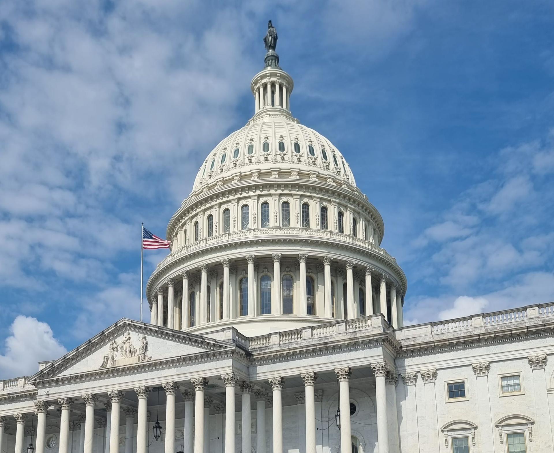 The U.S. Capitol symbolizes national governance, highlighting political tensions over AI regulations and security.
