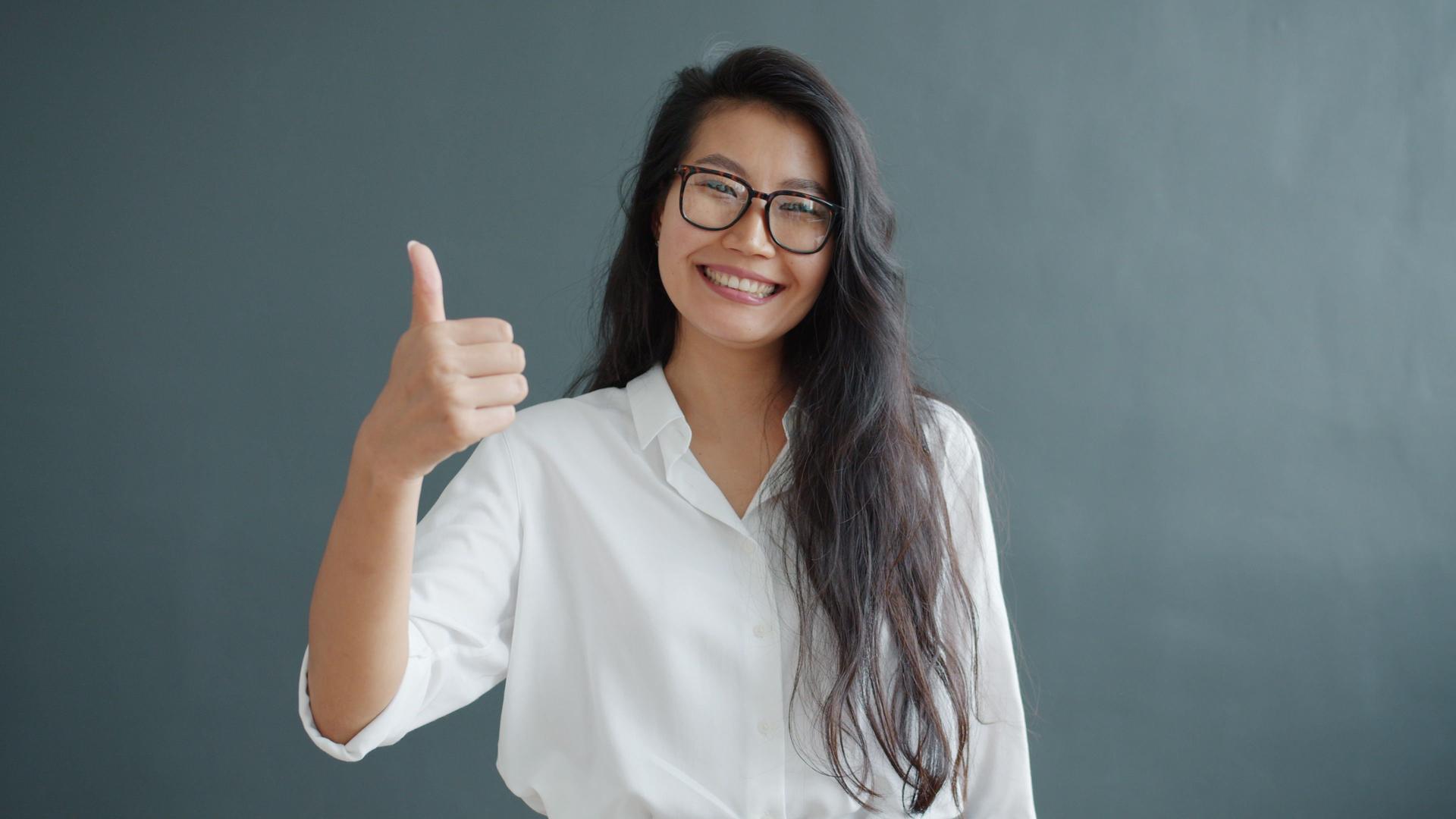 Smiling woman giving a thumbs-up while considering whether to recommend an AI advertiser