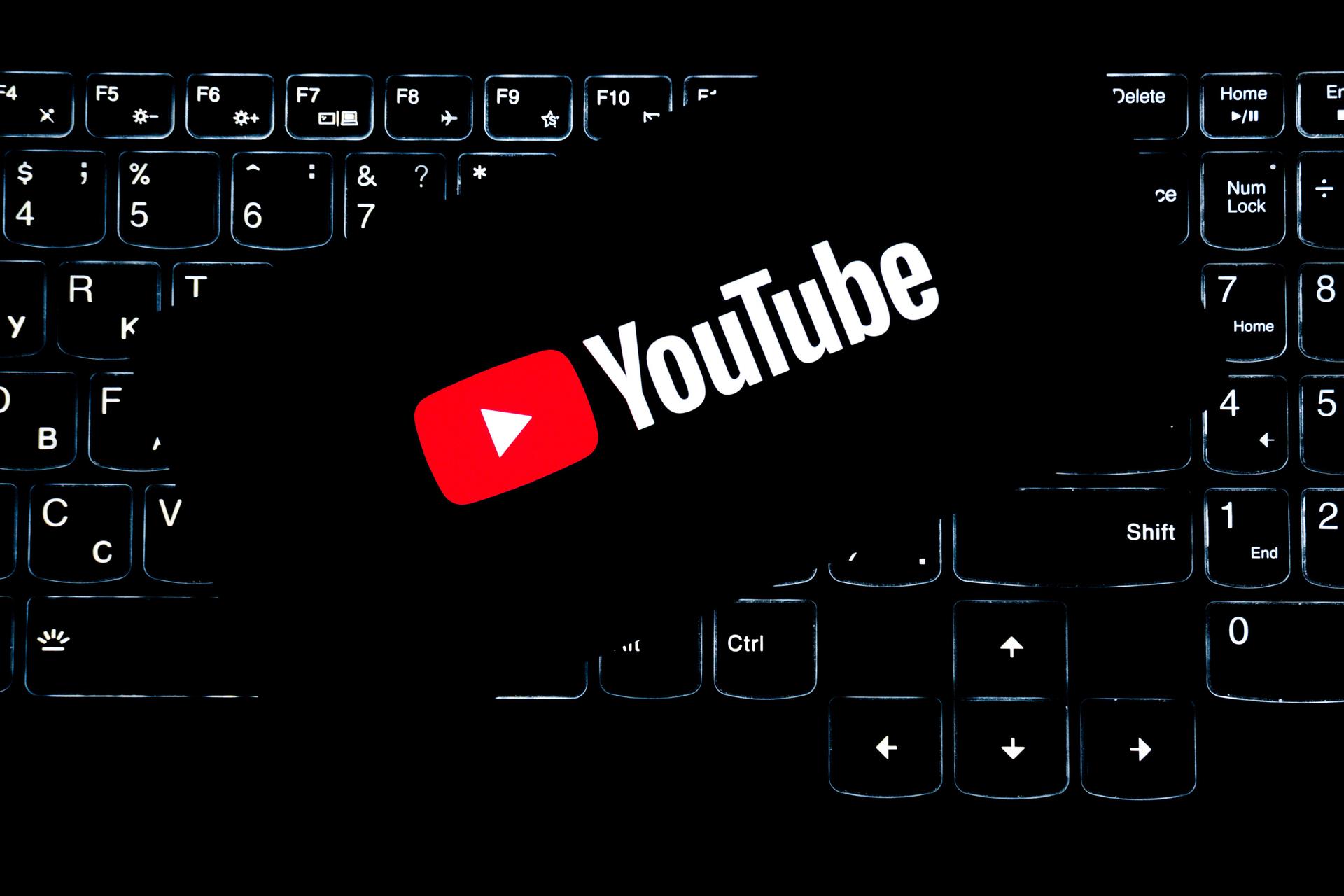 YouTube logo on a backlit keyboard representing the platform's terms in the Sora training data debate